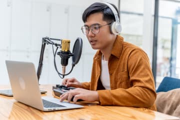 Student records and works on his laptop.