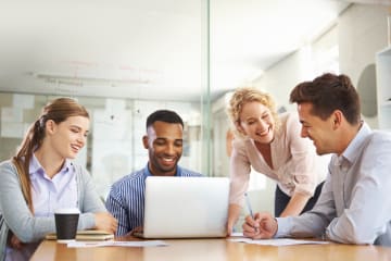 group of professionals meeting together and smiling