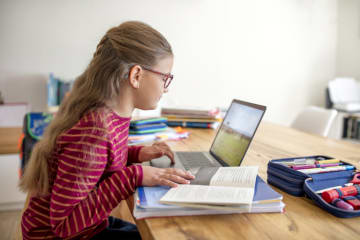 young student using laptop to learn and do homework