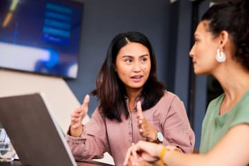 Woman speaking with her colleague.