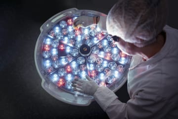 Creative Images & Video  Search by image or video Female engineer preparing operating theatre light in factory clean room - stock photo