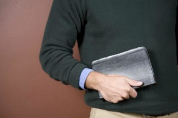 A student holding the Bible 
