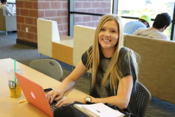 A student studying in the GCU library