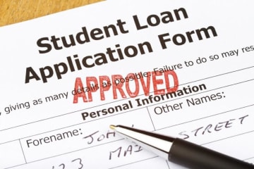 student loan application form with "approved" stamped on it