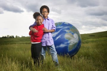 children with globe behind them