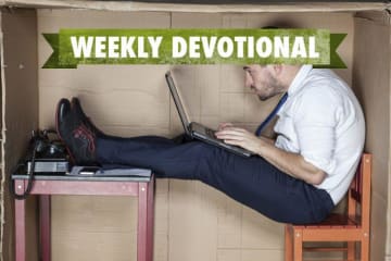 Man working on a computer inside a cramped space