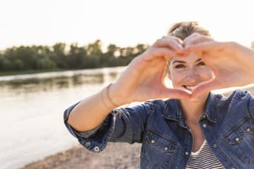 Woman making her hands a heart shape