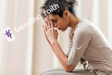 A person praying with the Trending Faith logo