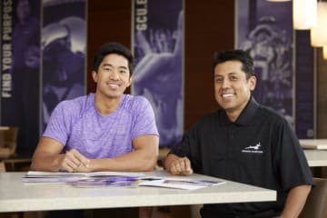 student and adult smiling