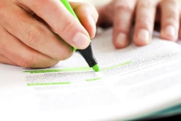 person highlighting in a book