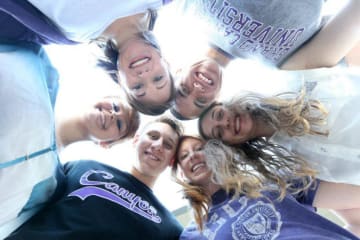 A group of GCU students huddling together