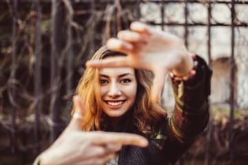 person holding hands out framing something