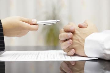 businessman offering a pen