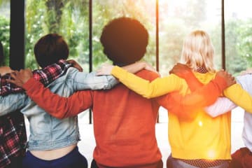A group of people with their arms around each other