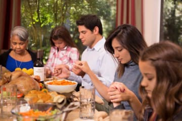 A family at the table on Thanksgiving