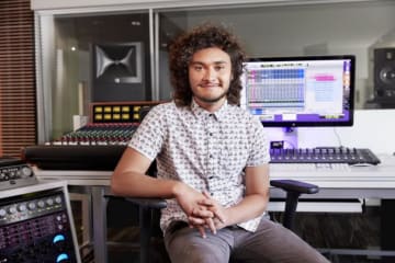 A student working in a sound mixing booth