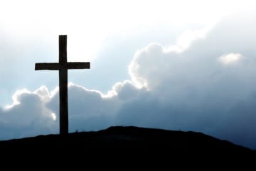 Cross on the hill with cloud in the scenery 