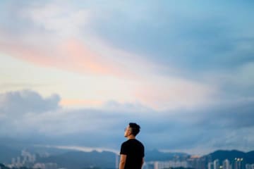 A person staring at the sunset