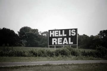 sign that reads "hell is real" 