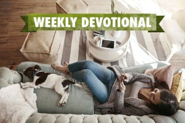 Girl sitting on couch with dog 