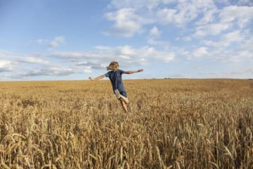 a girl running through a field