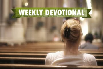 A woman sitting in a pew under the Weekly Devotional banner