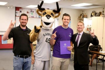 gcu mascot and three people smiling