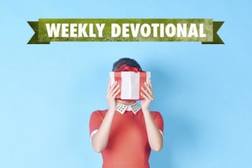 Weekly Devotional: Woman hiding behind a present