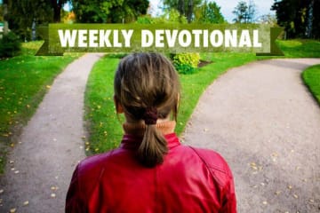 girl standing between two paths