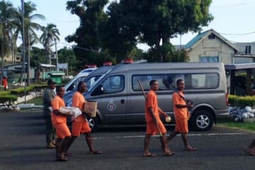 people wearing orange carrying different items