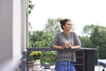 a woman outside with coffee in the morning