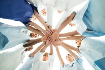 team or nurses in a huddle 