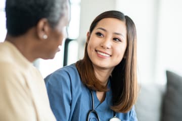 A nurse practitioner talks to an adult patient about their healthcare options.