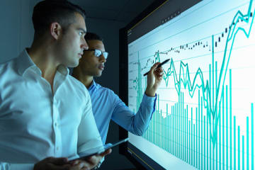 Computer science degree students analyzing data in computer lab