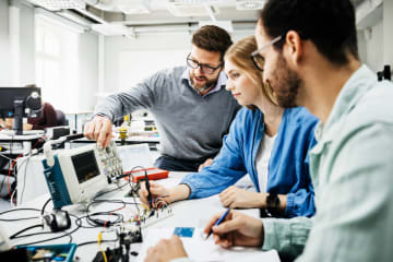 three students building STEM project
