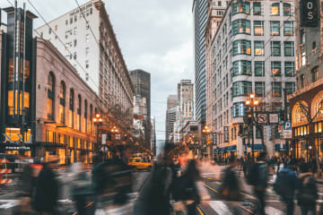 people walking quickly in a city