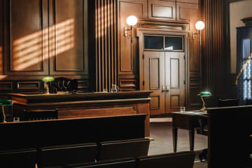 Image of an empty, dimly lit courtroom