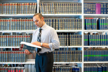 Man reading legal text in law library