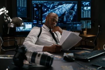 Detective sitting in office looking at papers