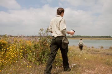 Two game wardens patrolling a river