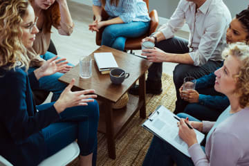 Addiction counselor leading group therapy session