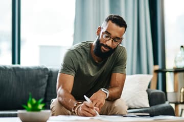 male student earning online business degree from home