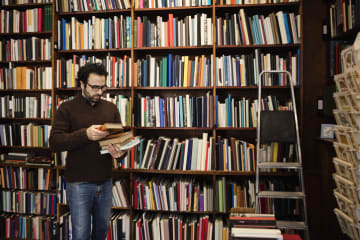 Doctoral student reading book in library