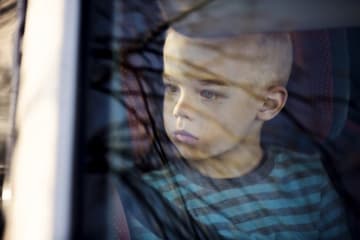 Student looking outside of car window