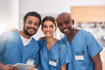 A portrait photo of three registered nurses inside a hospital 