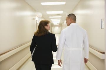 Healthcare administrator speaking with doctor