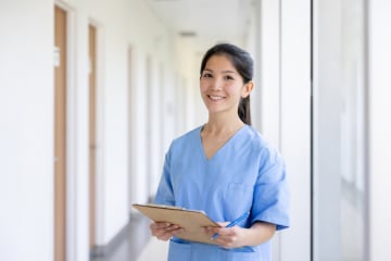 Nurse in hospital holding clipboard and getting nursing experience
