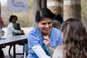 Community health worker with young patient