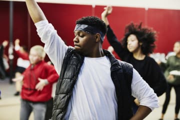 Dance teacher instructing class in studio