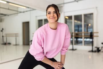 Dancer completing dance warmups in studio